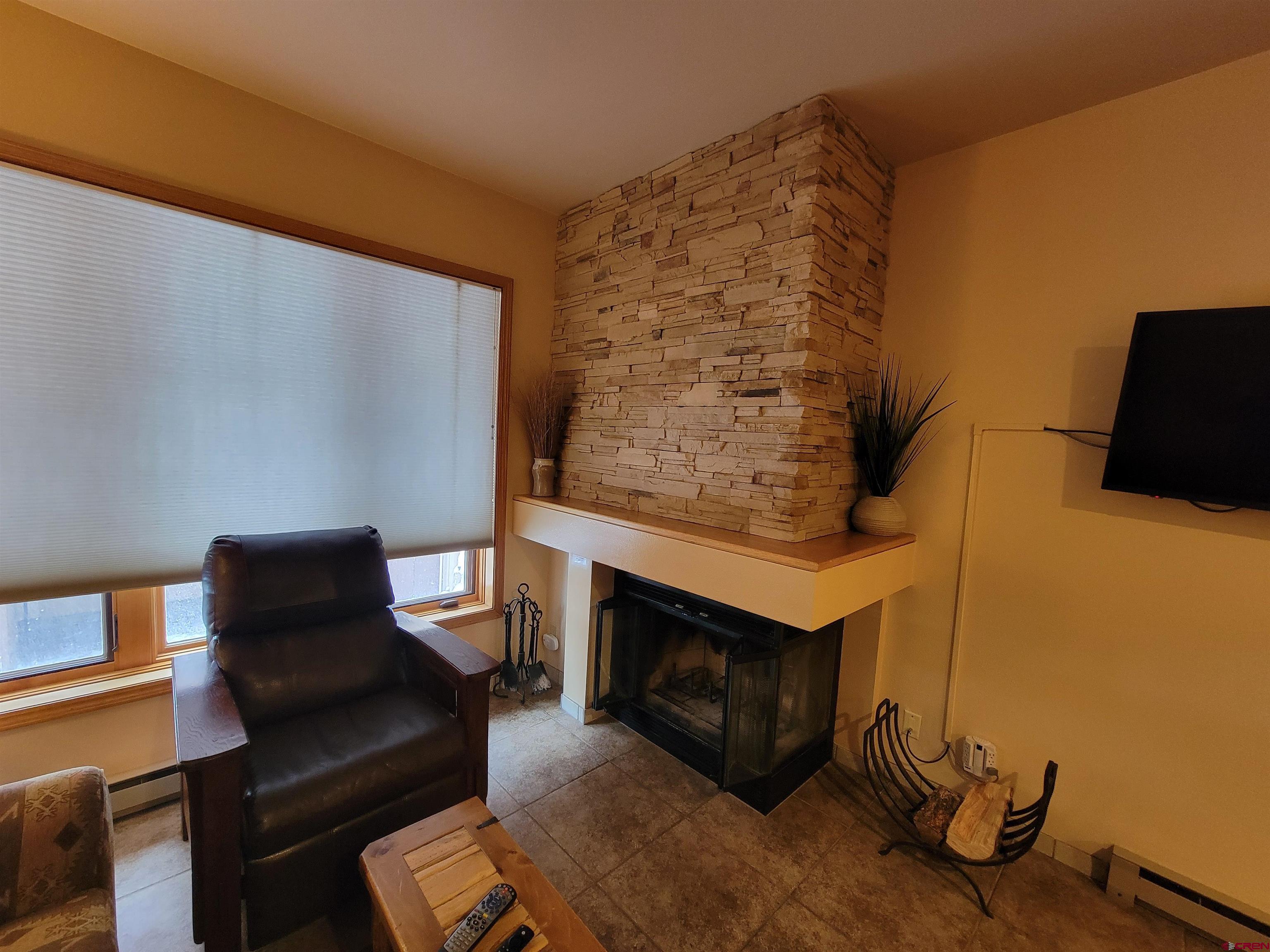 71 Needles Way, Unit 347 Durango, CO 81301 - Photo 22 of 31 a living room with furniture and a fireplace