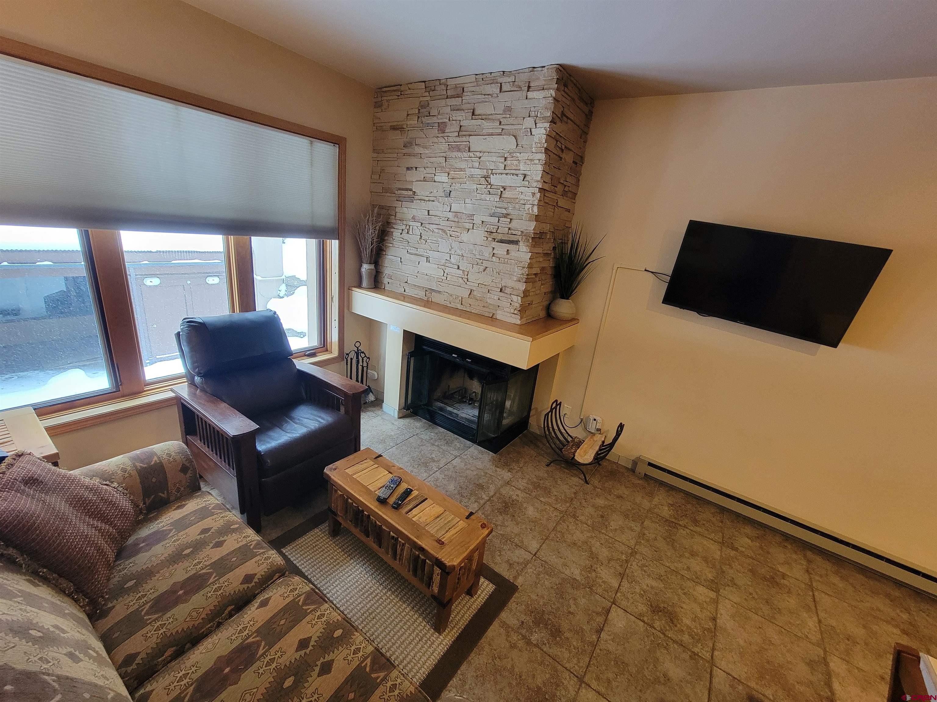 71 Needles Way, Unit 347 Durango, CO 81301 - Photo 7 of 31 a living room with furniture and a fireplace