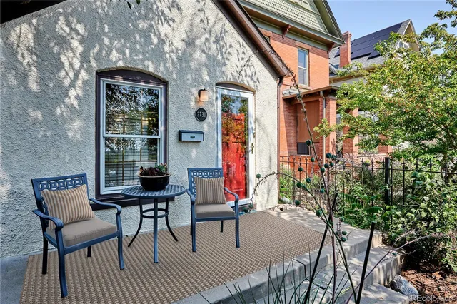 a living room with furniture a flat screen tv and a window