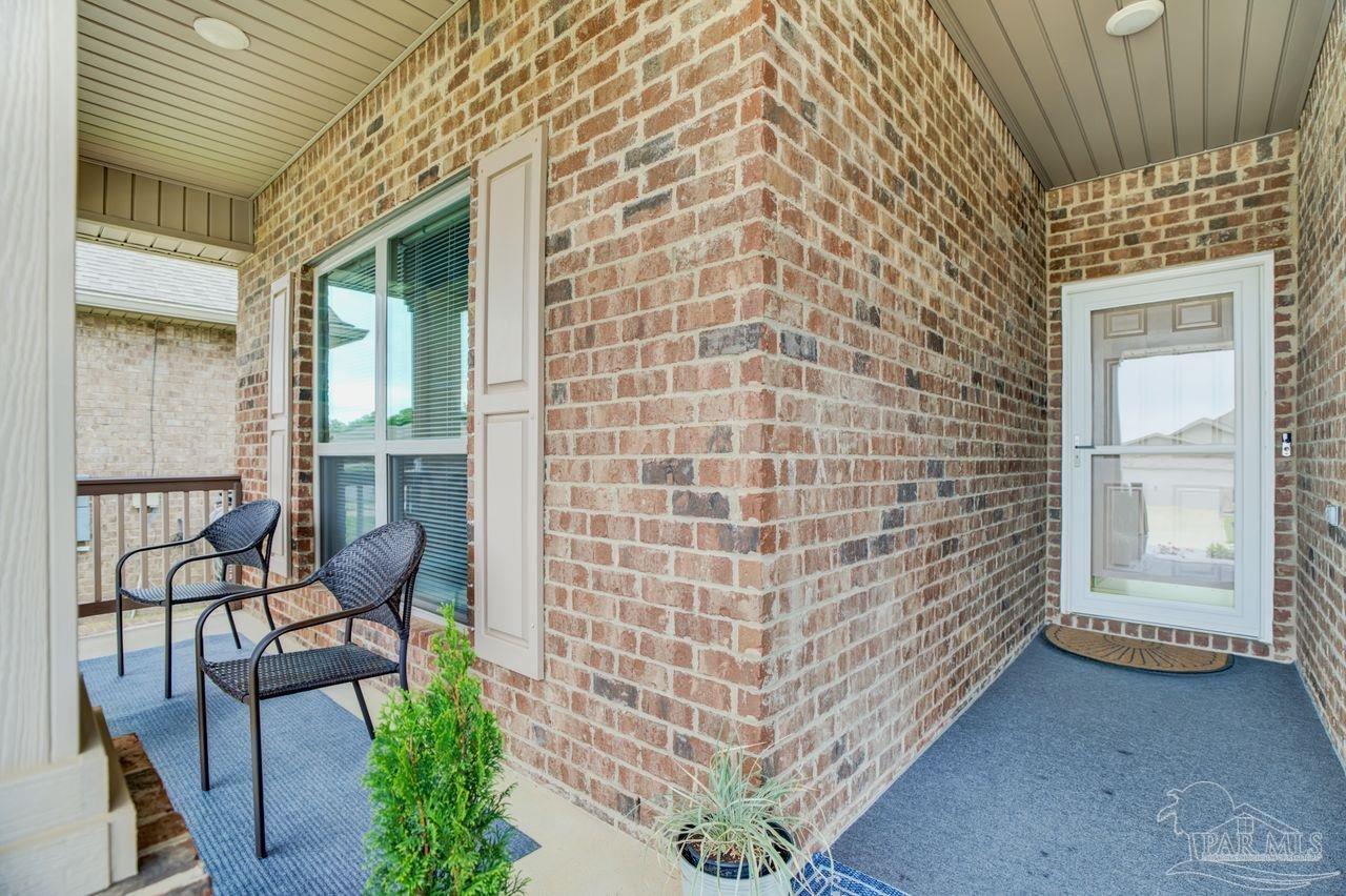 5364 Red Shoulder Road Pace, FL 32571 - Photo 6 of 46 a view of house with outdoor seating and wooden floor