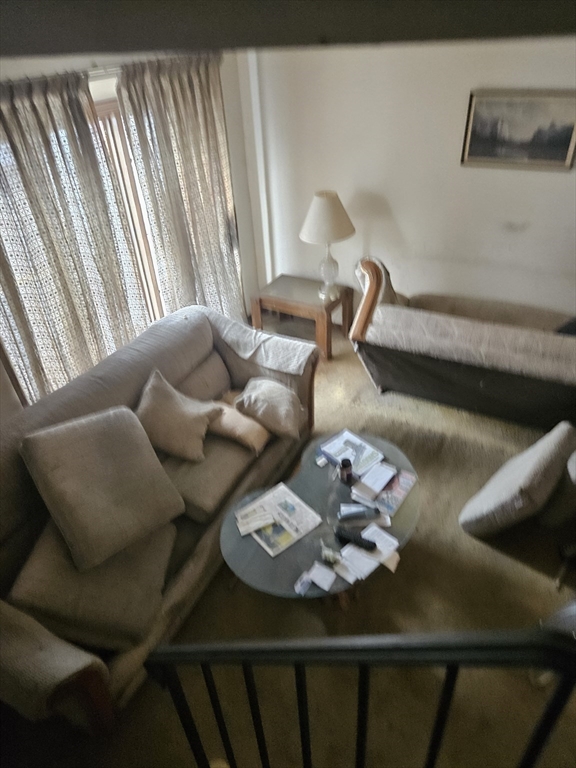 490 School Street, Unit 2 Lowell, MA 01851 - Photo 12 of 26 a bed with white sheets and a couch