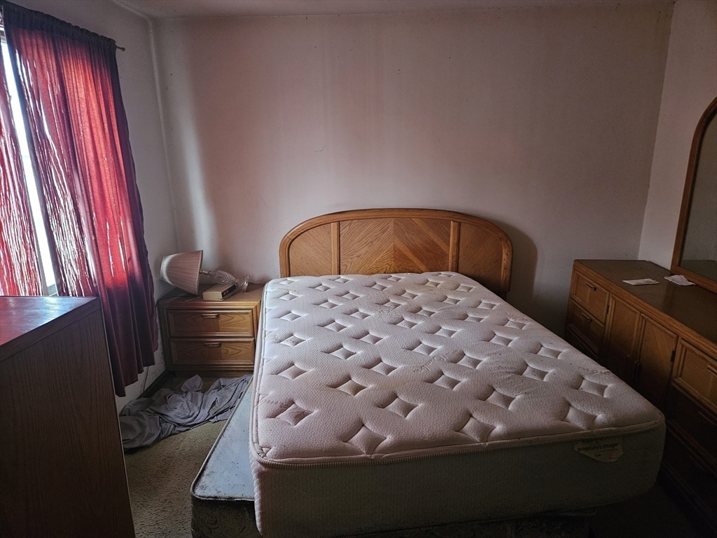 490 School Street, Unit 2 Lowell, MA 01851 - Photo 17 of 26 a bedroom with a bed and dresser
