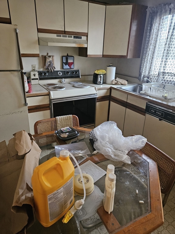 490 School Street, Unit 2 Lowell, MA 01851 - Photo 10 of 26 a kitchen with stainless steel appliances granite countertop a sink and a stove