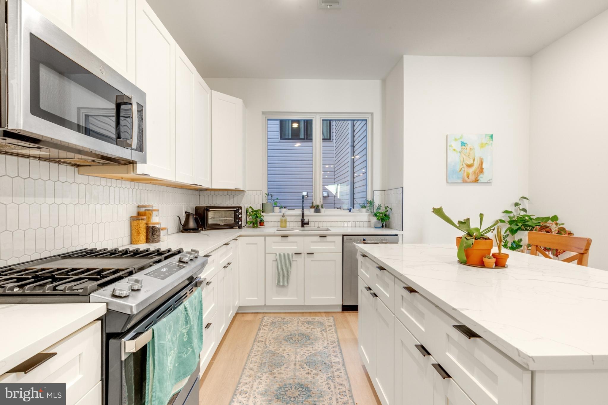 a kitchen with a sink stove and cabinets