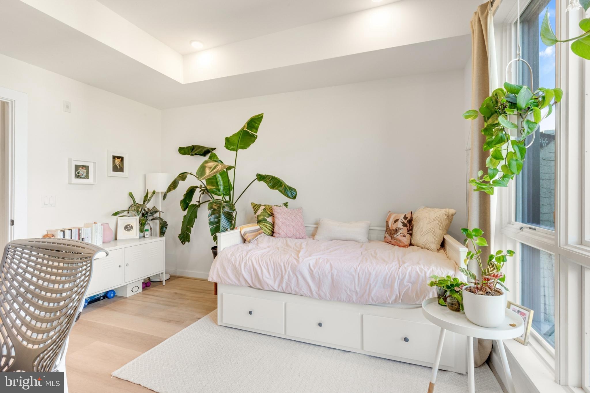 2212 North Front Street, Unit 5 Philadelphia, PA 19133 - Photo 12 of 25 a bedroom with a bed table and a potted plant