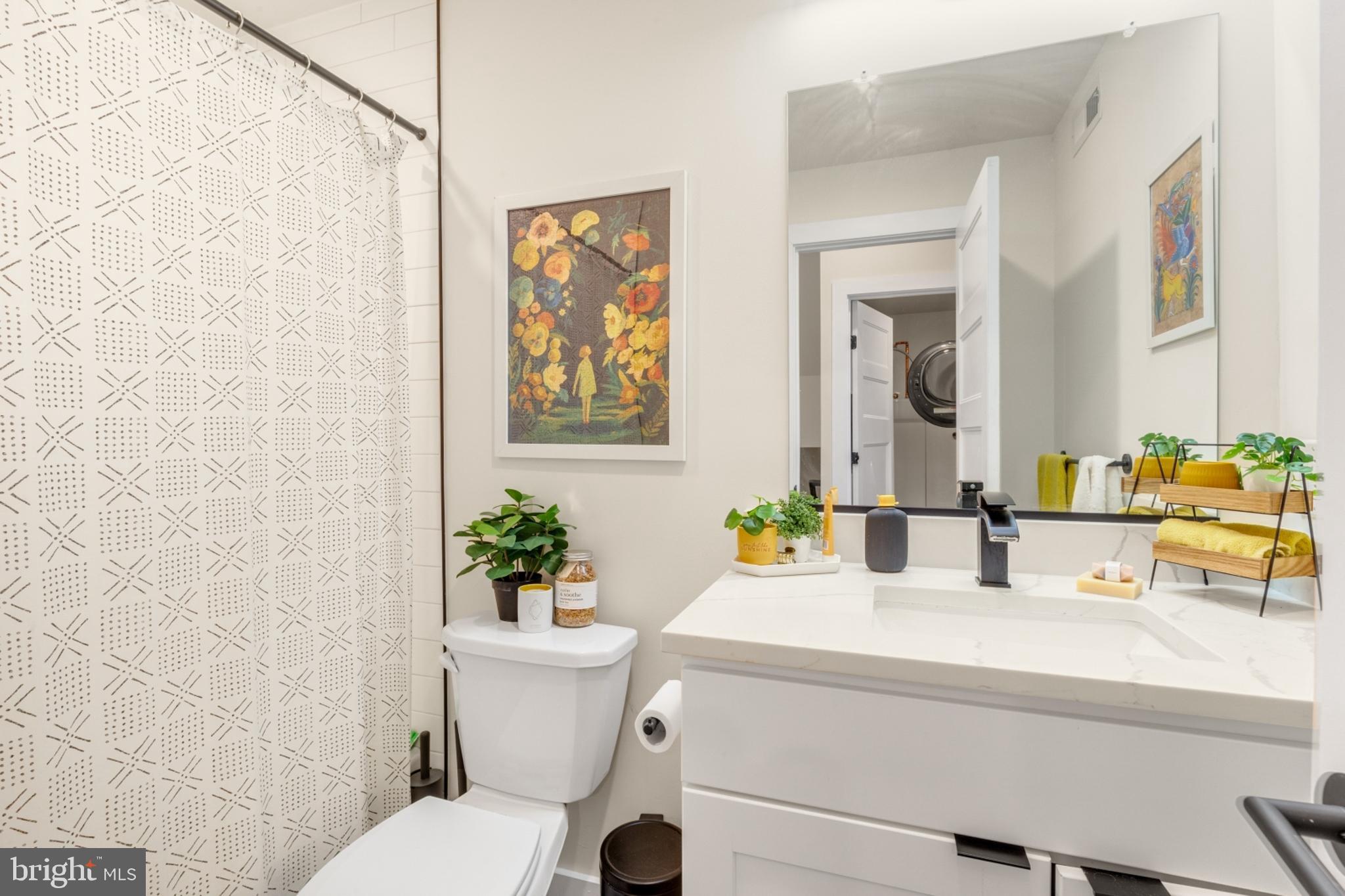 2212 North Front Street, Unit 5 Philadelphia, PA 19133 - Photo 14 of 25 a bathroom with a sink mirror vanity and toilet