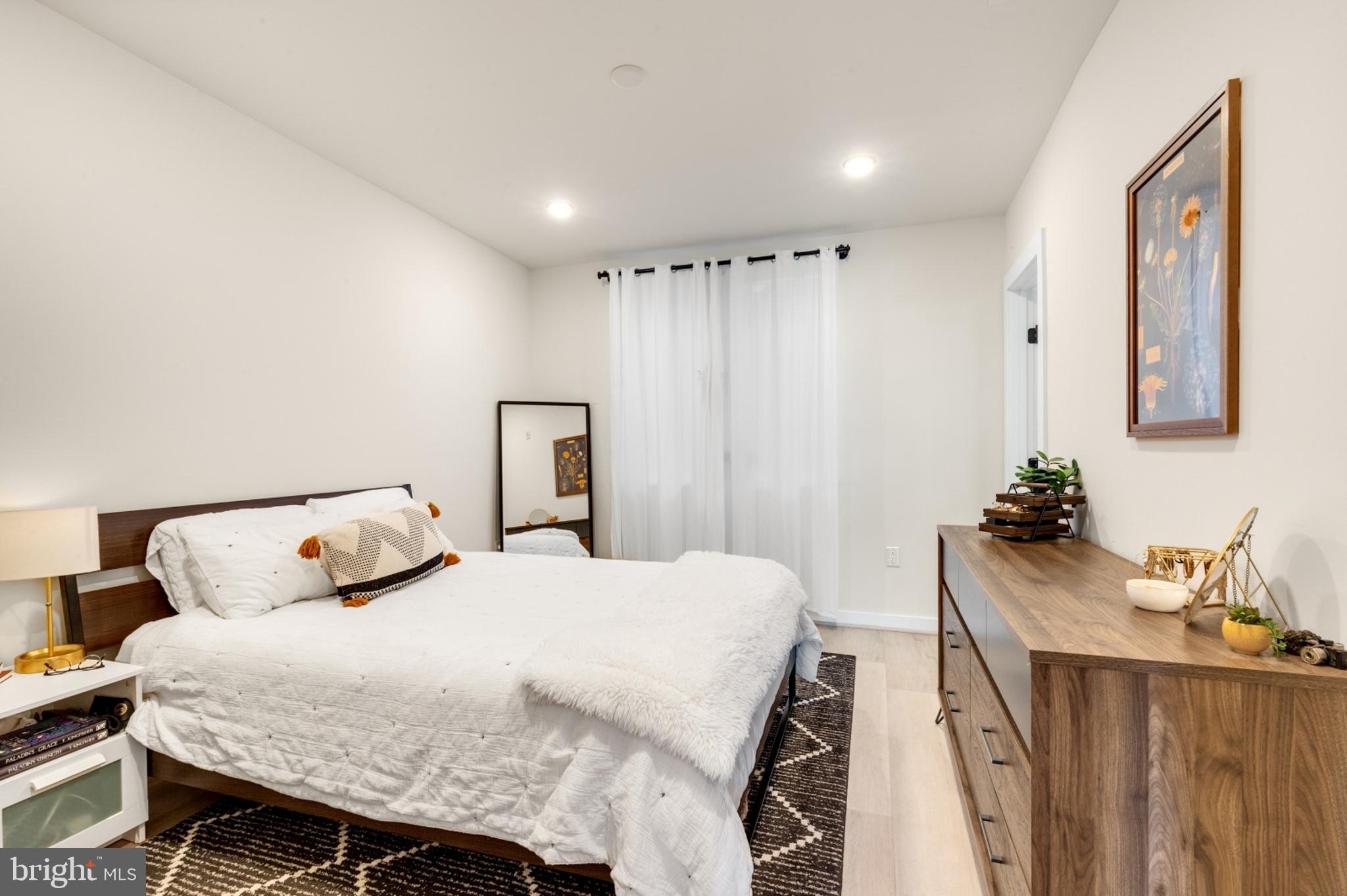 2212 North Front Street, Unit 5 Philadelphia, PA 19133 - Photo 15 of 25 a bedroom with a bed and a table in it