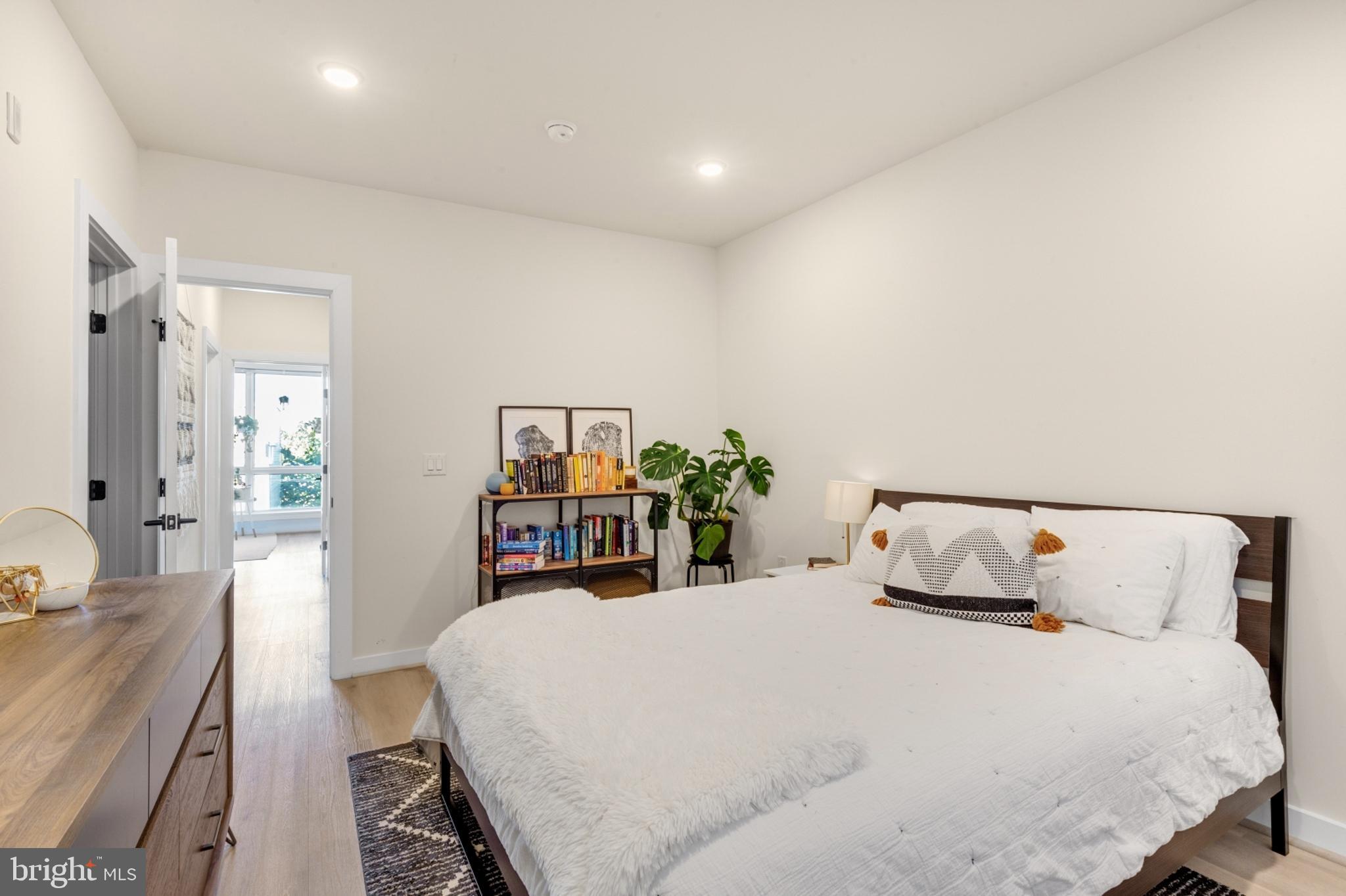 2212 North Front Street, Unit 5 Philadelphia, PA 19133 - Photo 17 of 25 a bed room with a bed and a large mirror