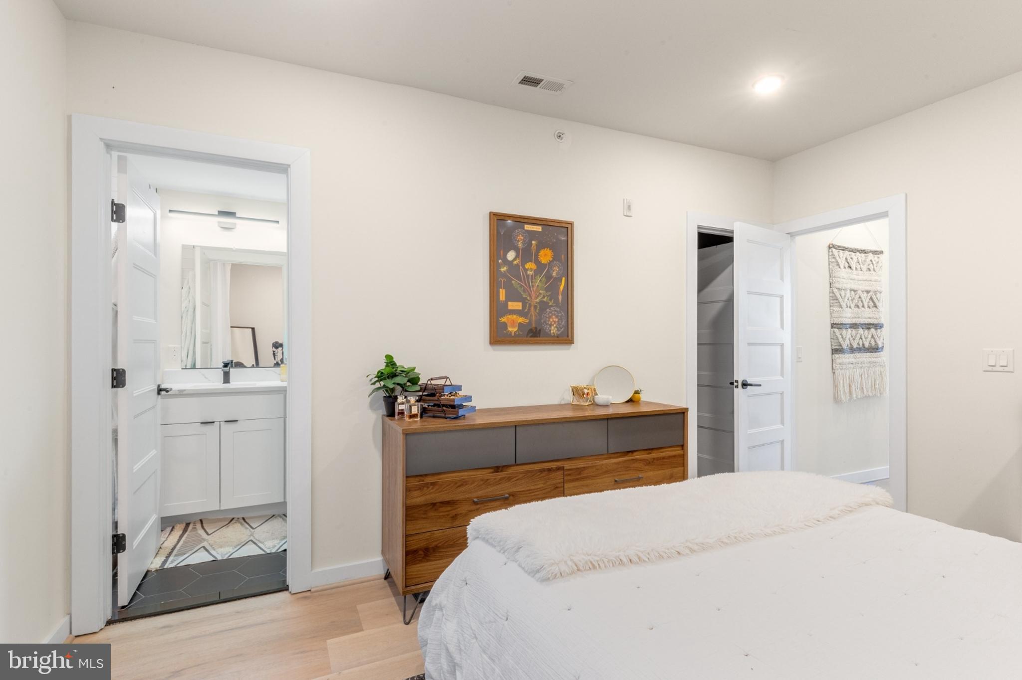 2212 North Front Street, Unit 5 Philadelphia, PA 19133 - Photo 18 of 25 a bedroom with a bed and a chandelier