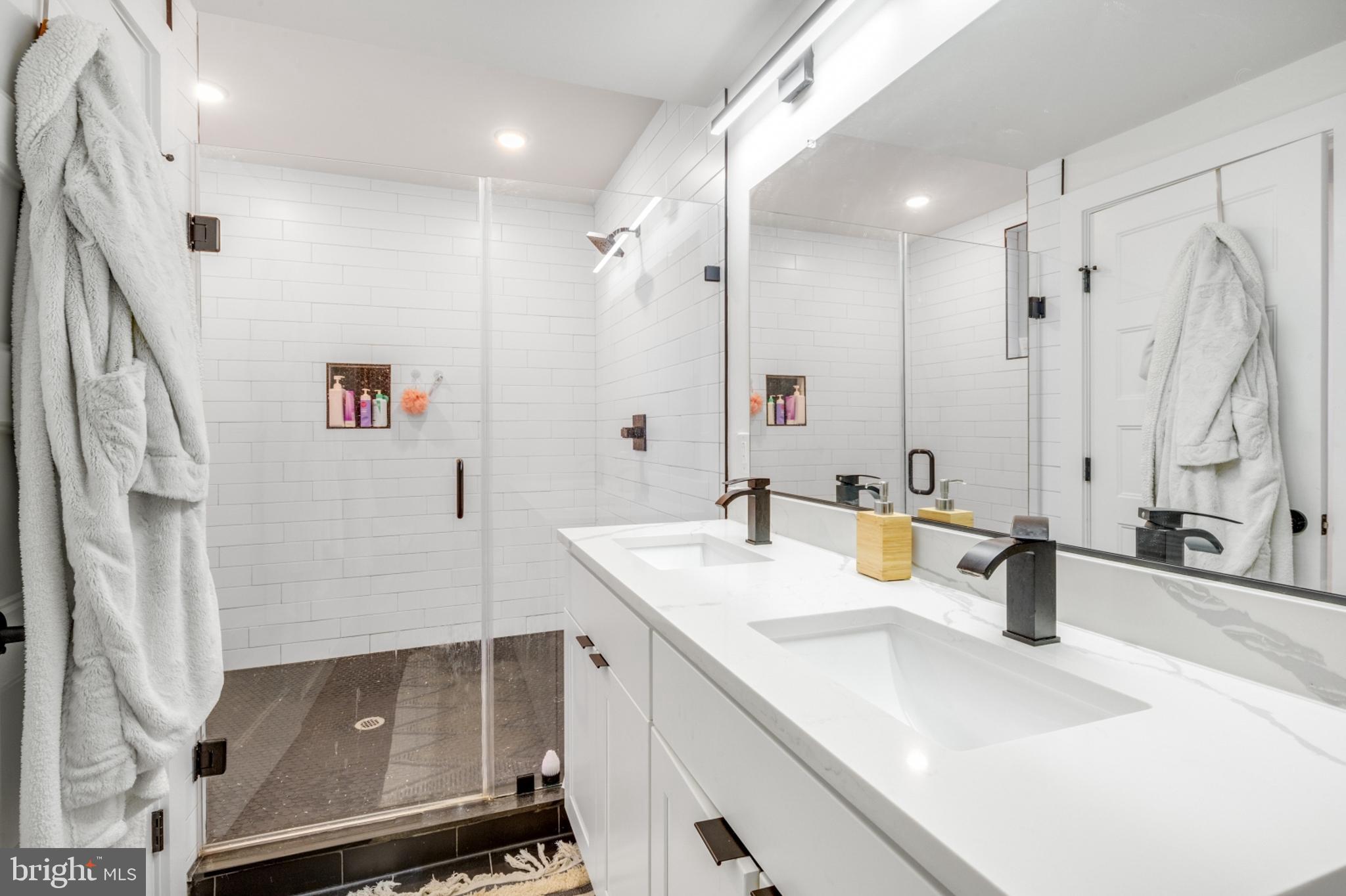 2212 North Front Street, Unit 5 Philadelphia, PA 19133 - Photo 19 of 25 a bathroom with a sink double vanity and a mirror