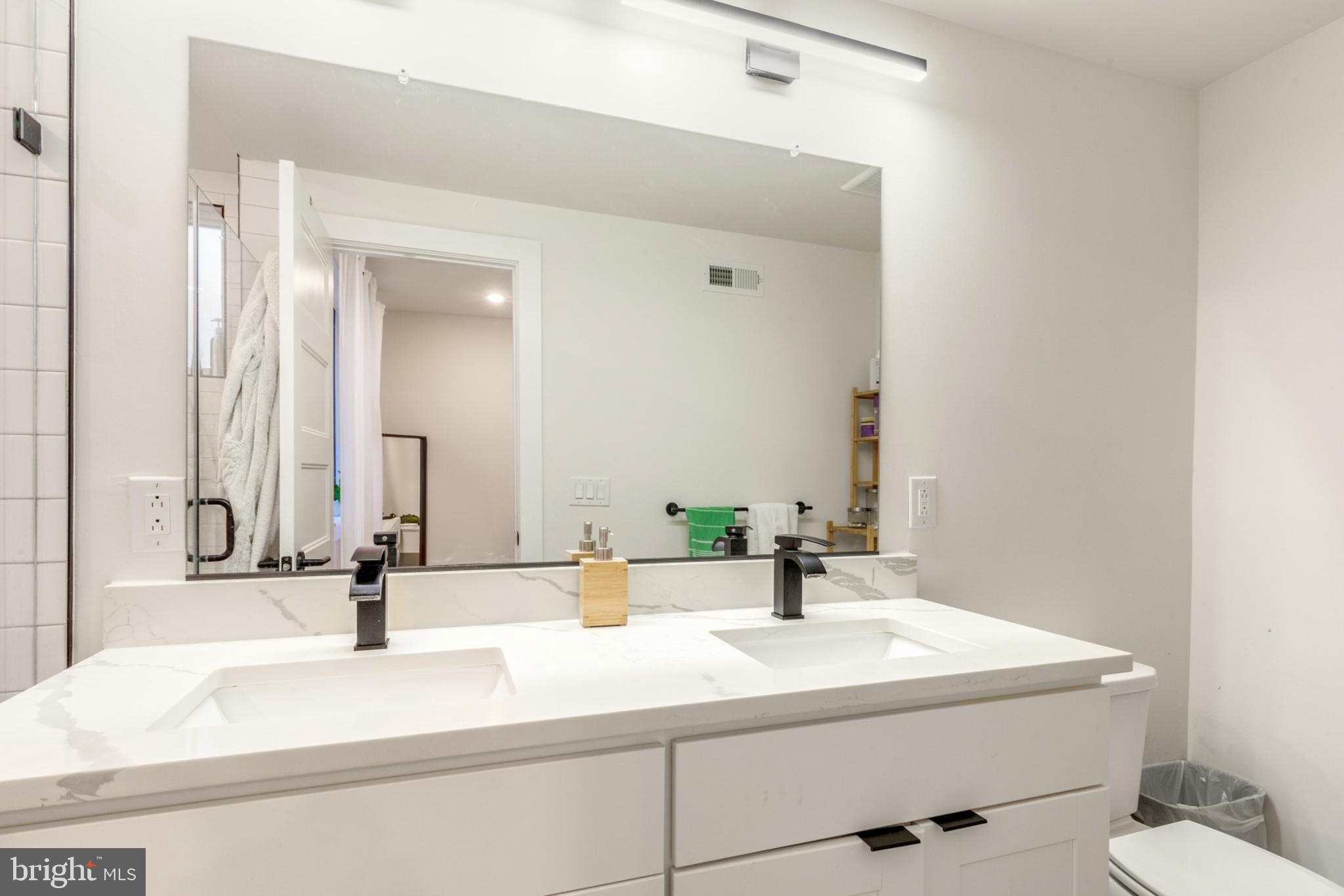 2212 North Front Street, Unit 5 Philadelphia, PA 19133 - Photo 20 of 25 a bathroom with a sink and a mirror