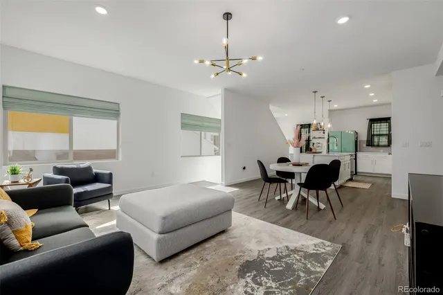 a living room with furniture a window and a table