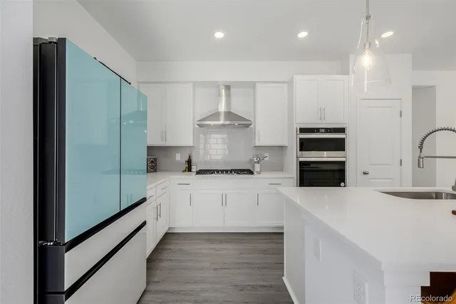 a kitchen with stainless steel appliances a refrigerator sink and stove