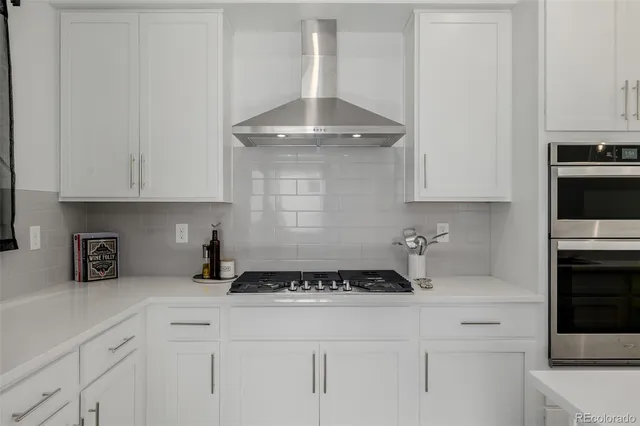 a kitchen with a stove and cabinets