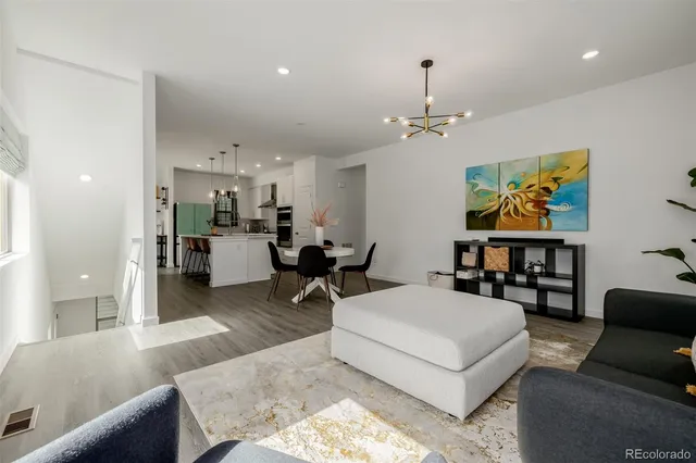 a living room with furniture and kitchen view