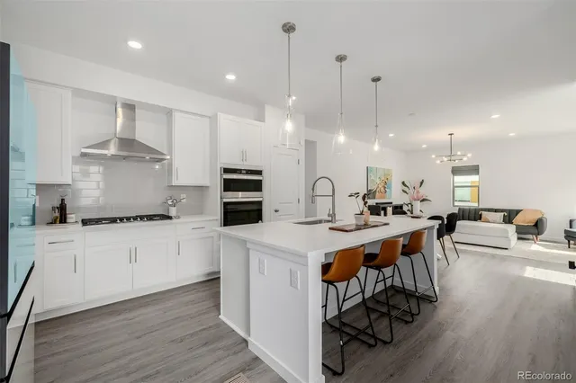 a kitchen with stainless steel appliances kitchen island a large island in the center