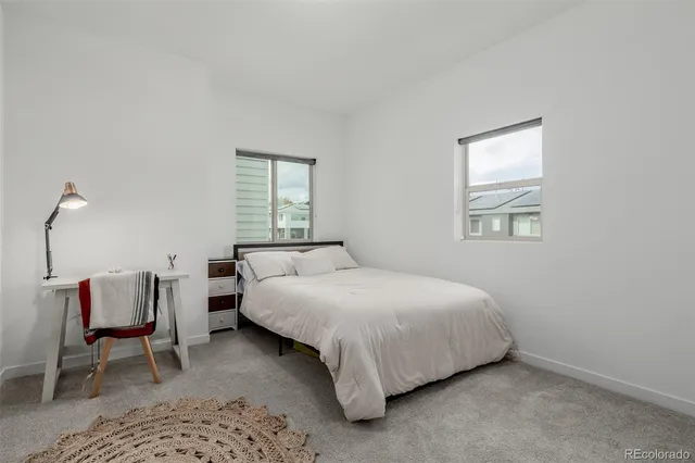 a bedroom with a bed chair and window