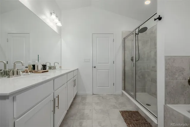 a spacious bathroom with double sink and shower