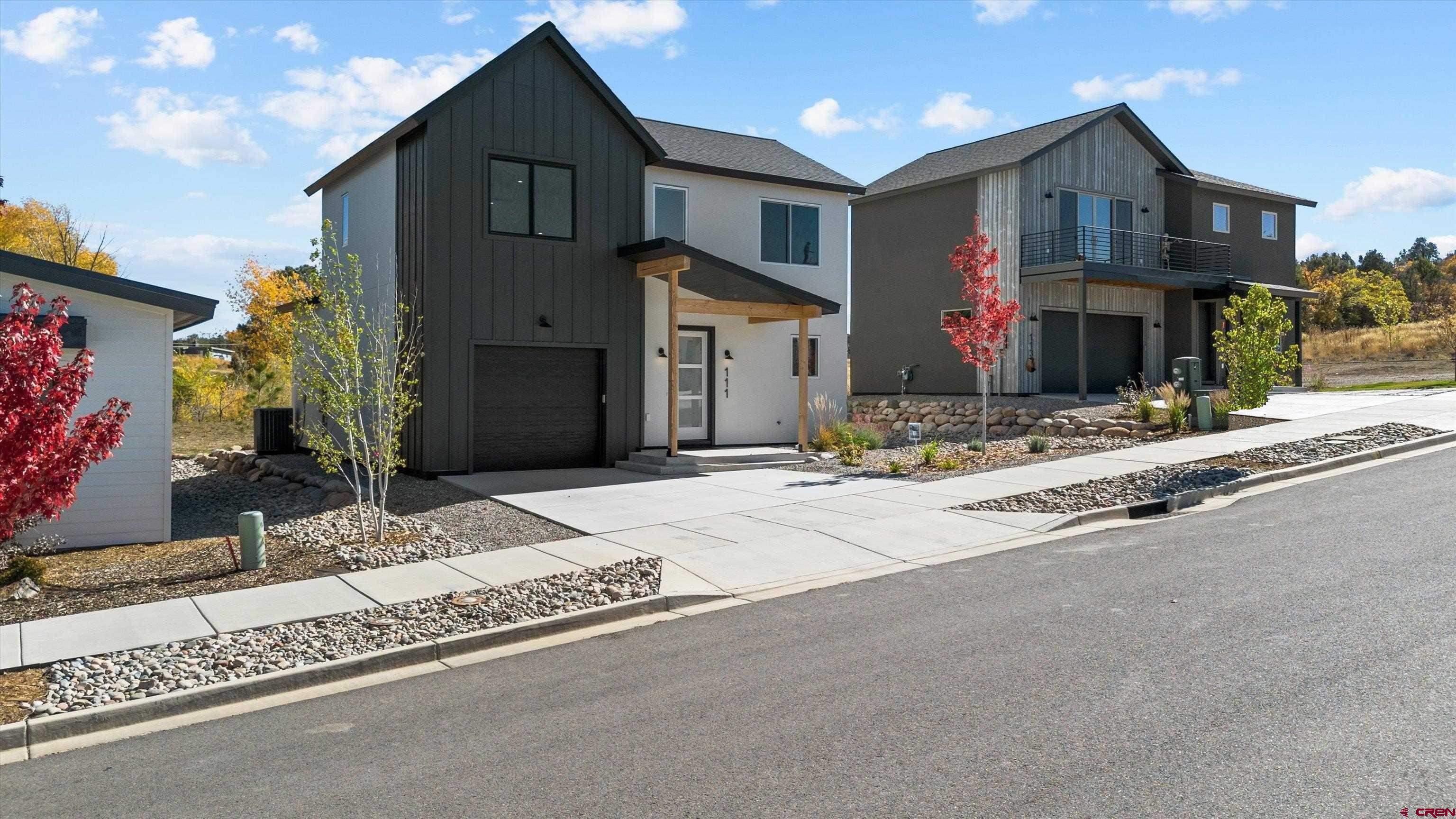 111 Elevation Drive Durango, CO 81303 - Photo 1 of 33 a front view of a house with a yard and garage