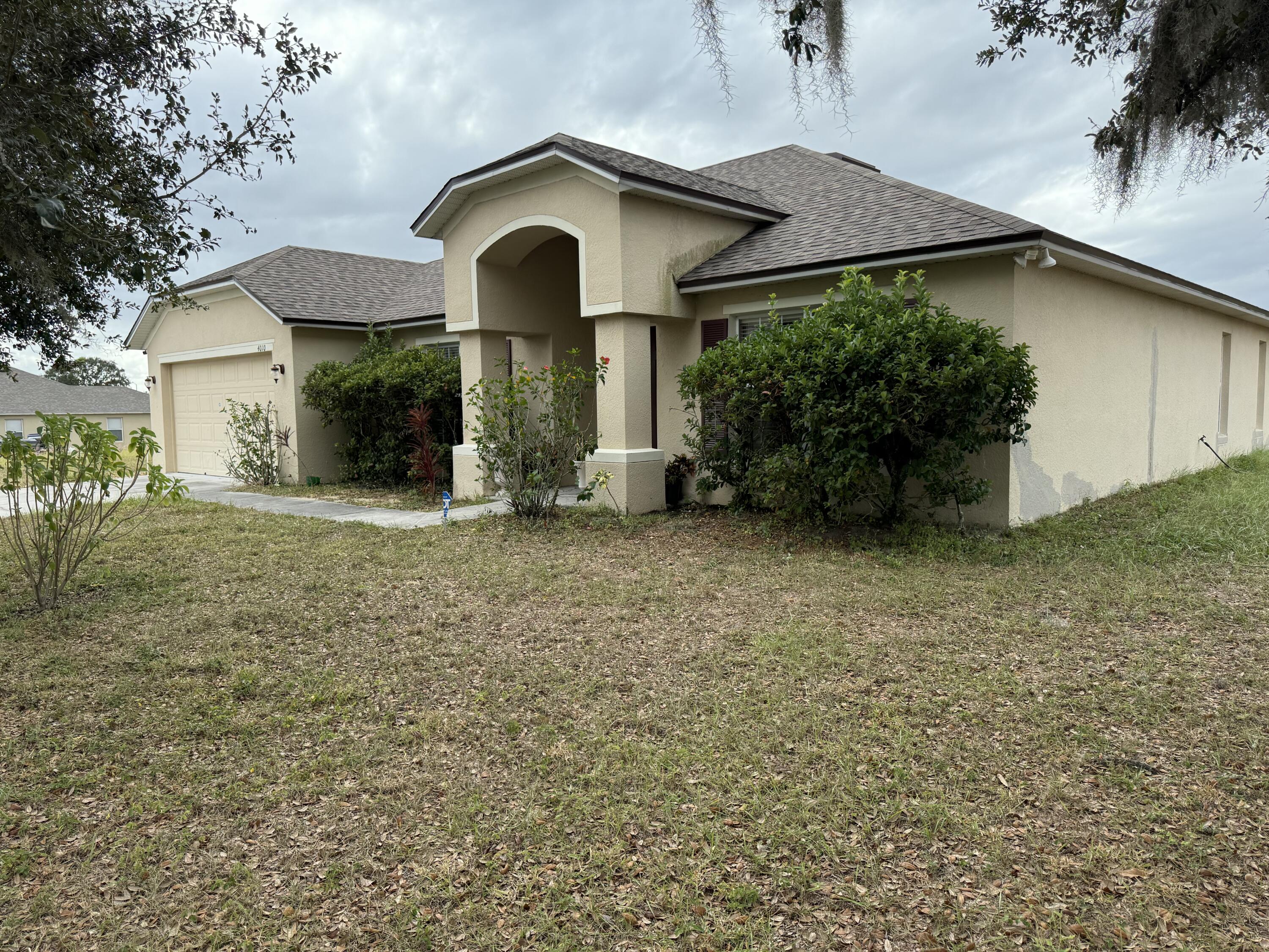 4010 Watkins Road Haines City, FL 33844 - Photo 2 of 8 a front view of a house with garden