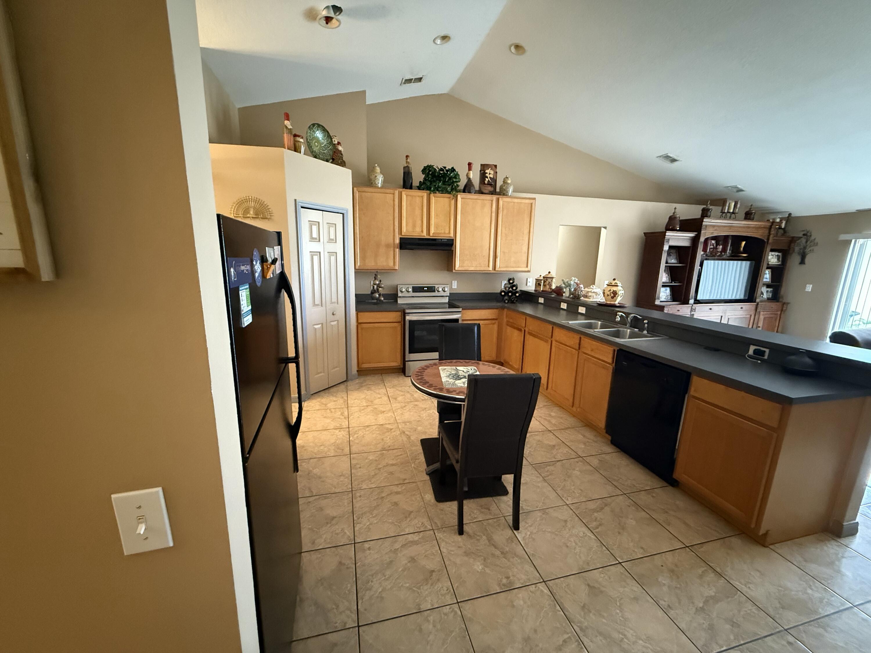 4010 Watkins Road Haines City, FL 33844 - Photo 7 of 8 a kitchen with stainless steel appliances a refrigerator a sink a stove a counter top space and cabinets
