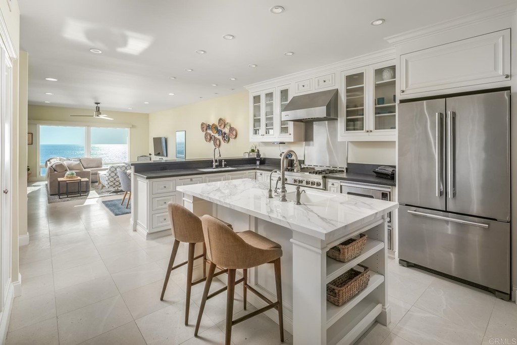 510 4th Street, Unit 3C Encinitas, CA 92024 - Photo 11 of 30 a kitchen with a center island appliances and cabinets