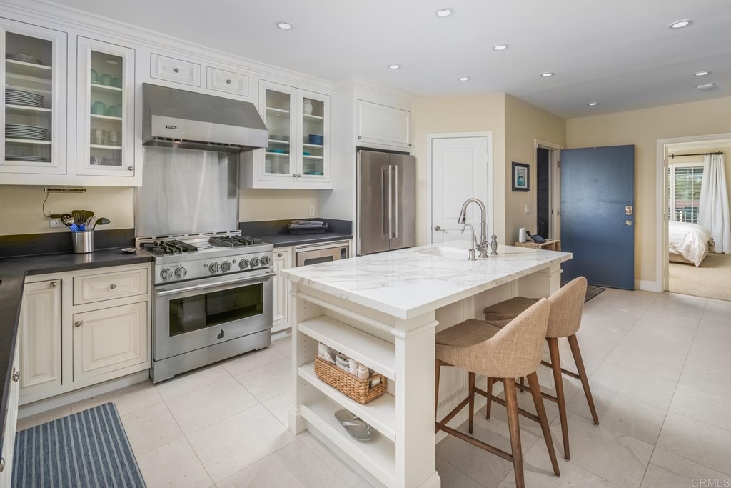 510 4th Street, Unit 3C Encinitas, CA 92024 - Photo 12 of 30 a kitchen with a stove a sink and a refrigerator