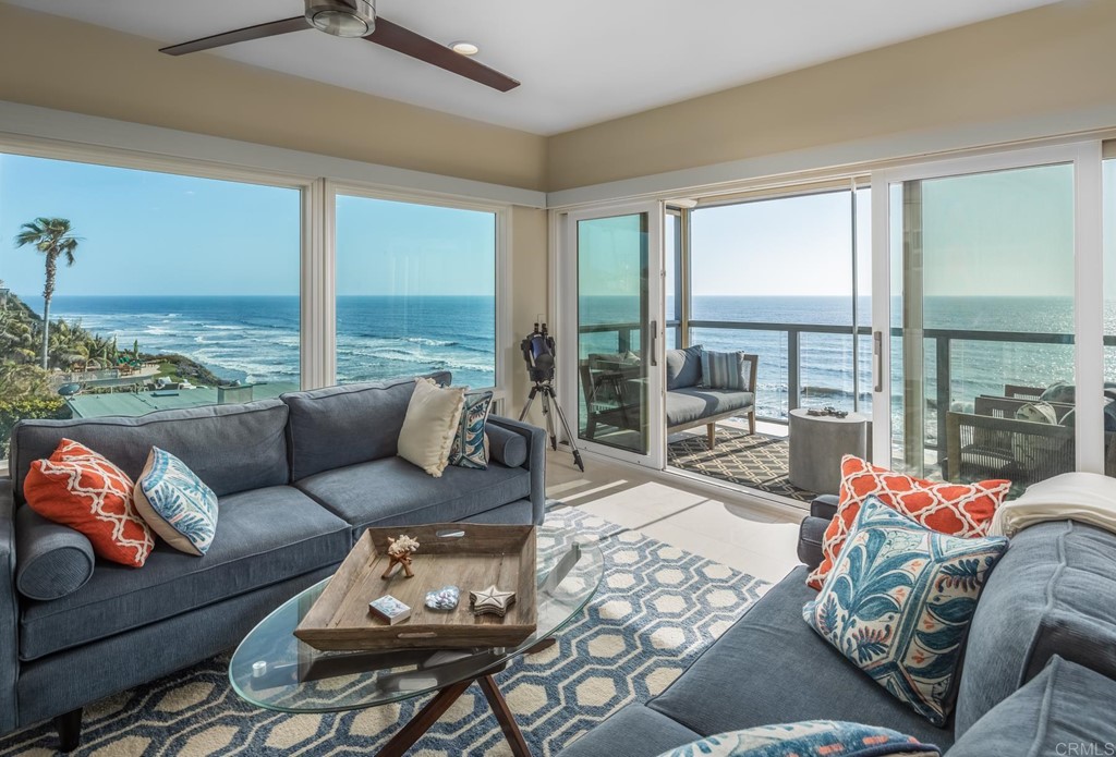 510 4th Street, Unit 3C Encinitas, CA 92024 - Photo 2 of 30 a living room with furniture and floor to ceiling windows