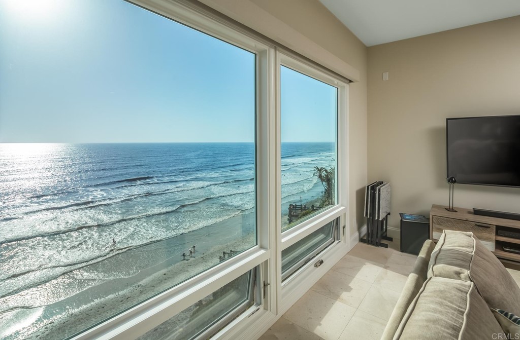 510 4th Street, Unit 3C Encinitas, CA 92024 - Photo 7 of 30 a living room with a flat screen tv and a floor to ceiling window