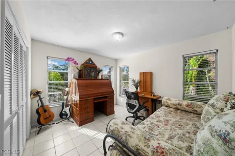 a bedroom with furniture and a window