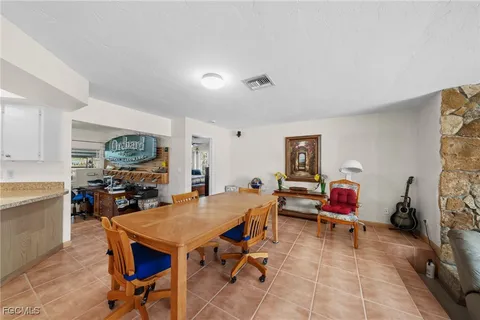 a bedroom with a bed dresser and flat screen tv