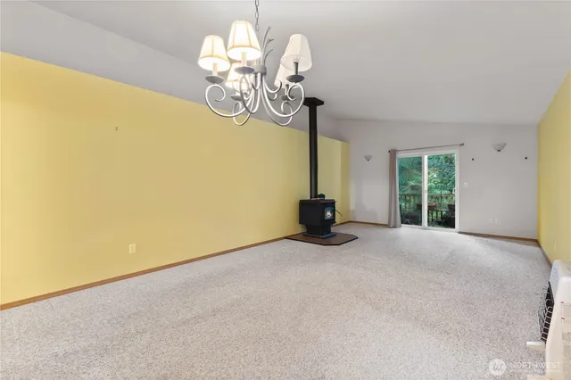 a view of an empty room with chandelier