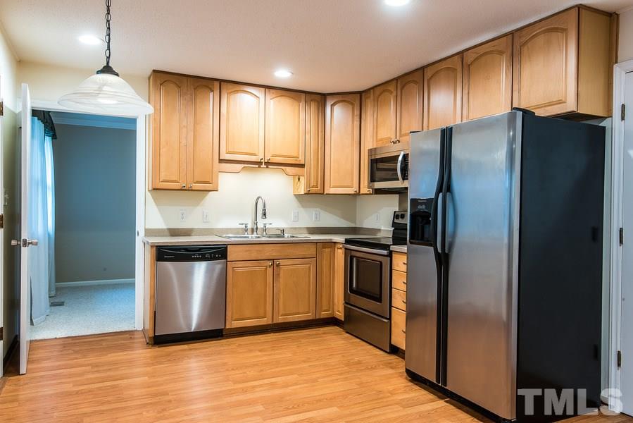 3308 Wade Avenue Raleigh, NC 27607 - Photo 14 of 24 a kitchen with granite countertop stainless steel appliances a refrigerator cabinets and wooden floor