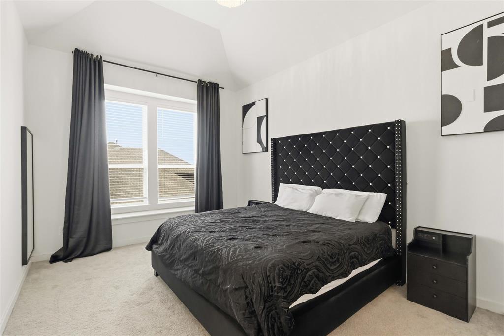 1128 Queensdown Way Forney, TX 75126 - Photo 14 of 25 a bedroom with a bed and wooden floor