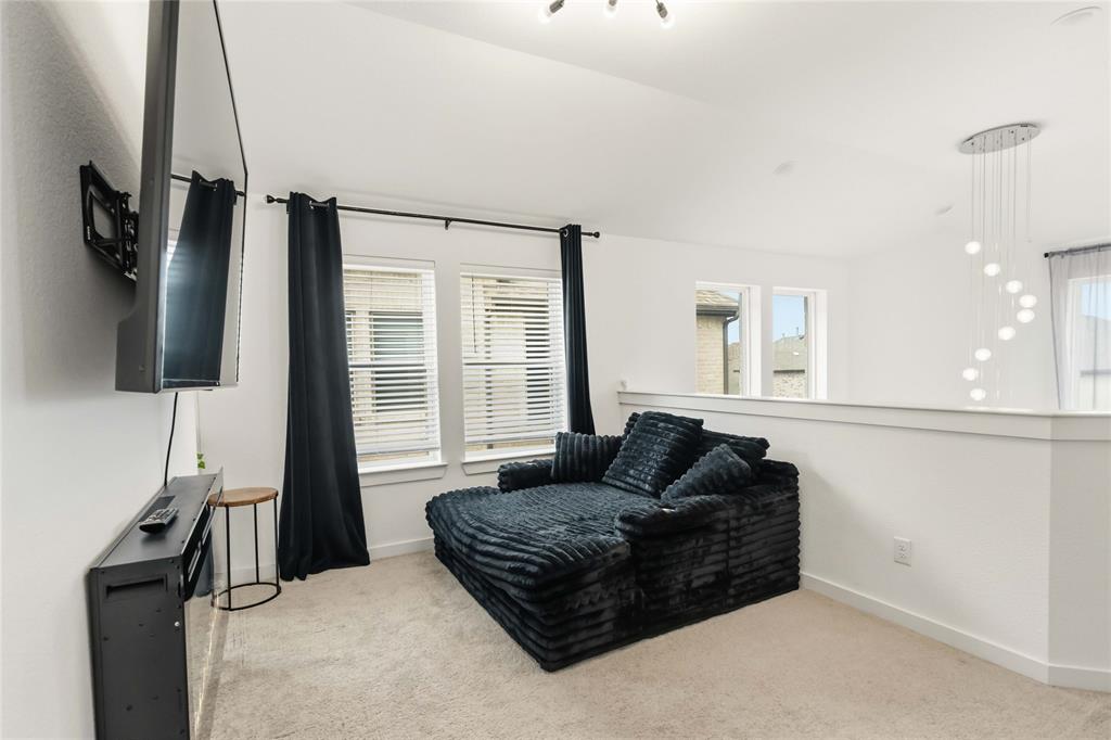 1128 Queensdown Way Forney, TX 75126 - Photo 16 of 25 a living room with furniture and a flat screen tv