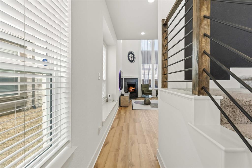 1128 Queensdown Way Forney, TX 75126 - Photo 7 of 25 a living room with furniture and a fireplace