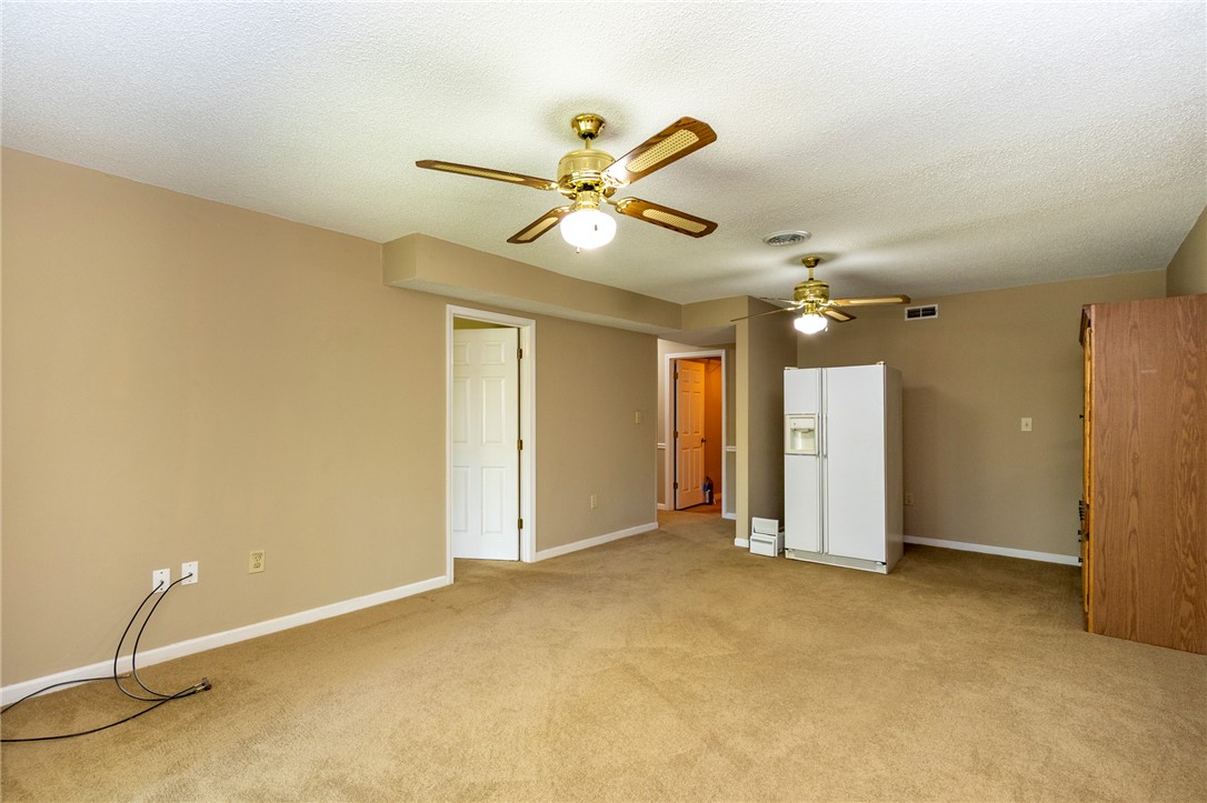 1302 Leeward Road Anderson, SC 29625 - Photo 32 of 50 A spacious room with warm neutral walls and inviting carpet, perfect for versatile living arrangements.