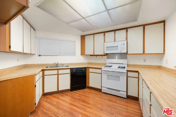 a kitchen with a stove a sink and a refrigerator