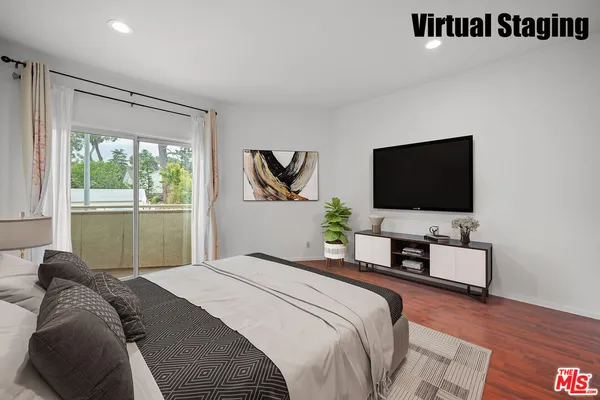 a bedroom with a bed and a flat screen tv