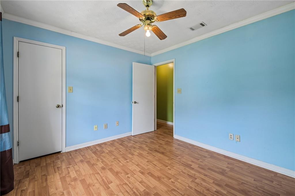1318 Panhandle Way Hampton, GA 30228 - Photo 16 of 22 a view of a big room with a ceiling fan and a wooden floor