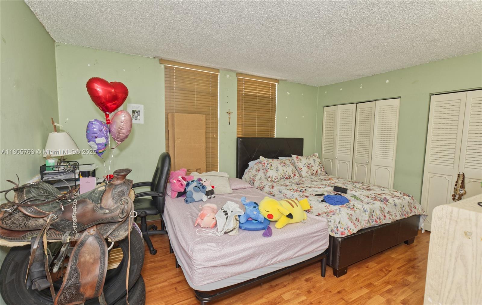 1750 West 46th Street, Unit 503 Hialeah, FL 33012 - Photo 12 of 24 a bedroom with furniture and a bed