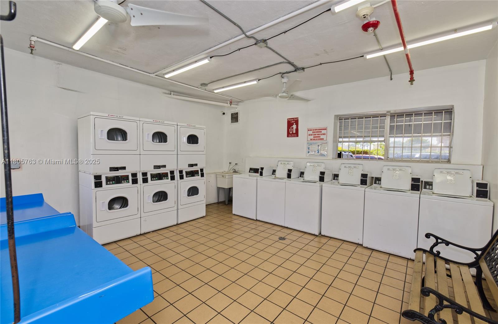 1750 West 46th Street, Unit 503 Hialeah, FL 33012 - Photo 22 of 24 a kitchen with stainless steel appliances kitchen island granite countertop a sink and white cabinets