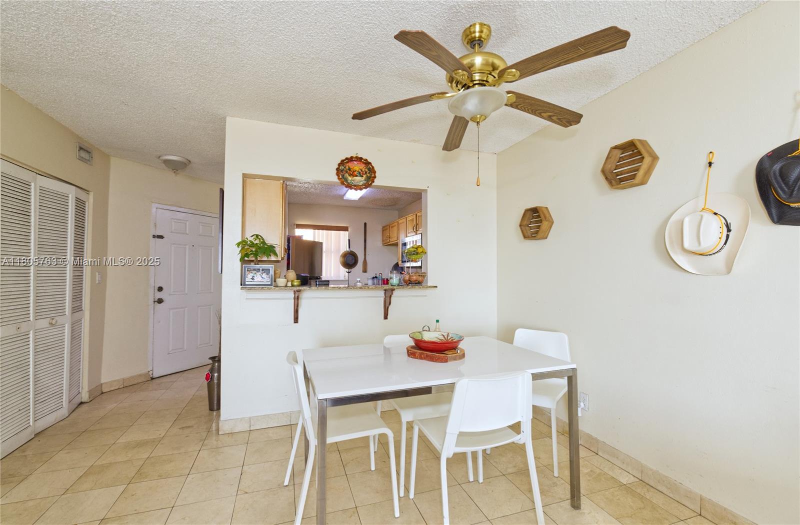 1750 West 46th Street, Unit 503 Hialeah, FL 33012 - Photo 6 of 24 a dining room with chandelier fan and wooden floor