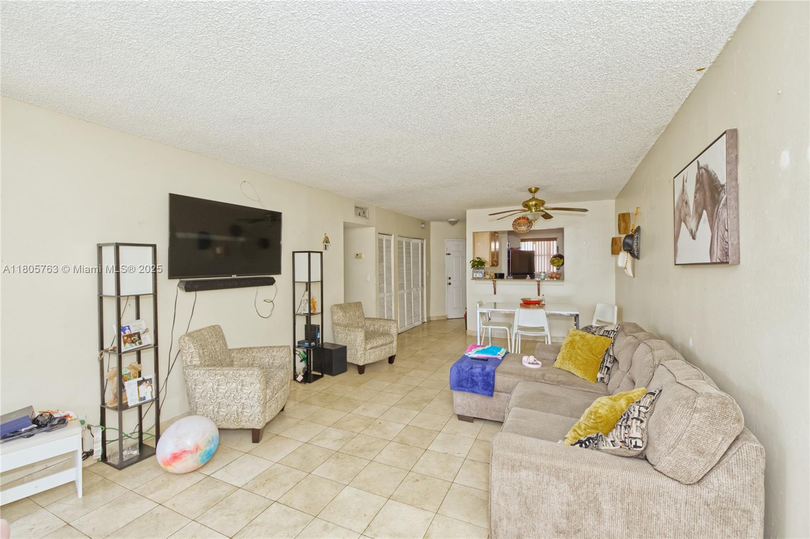 1750 West 46th Street, Unit 503 Hialeah, FL 33012 - Photo 7 of 24 a living room with furniture and a flat screen tv