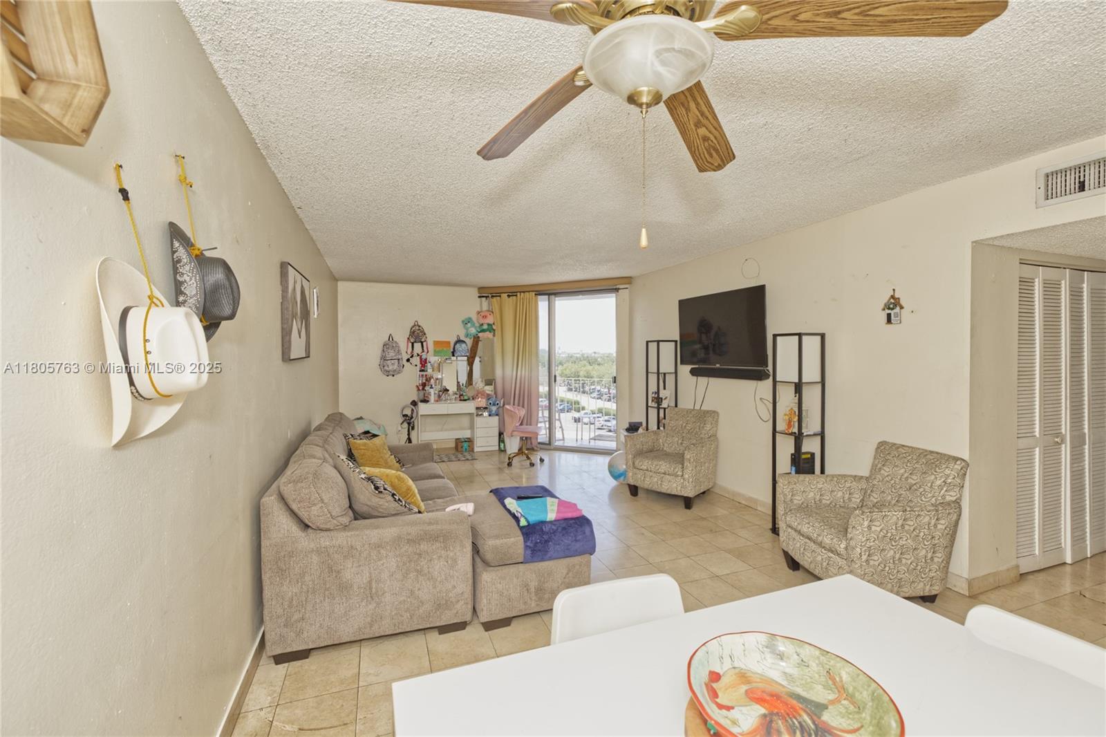 1750 West 46th Street, Unit 503 Hialeah, FL 33012 - Photo 8 of 24 a living room with furniture and a floor to ceiling window