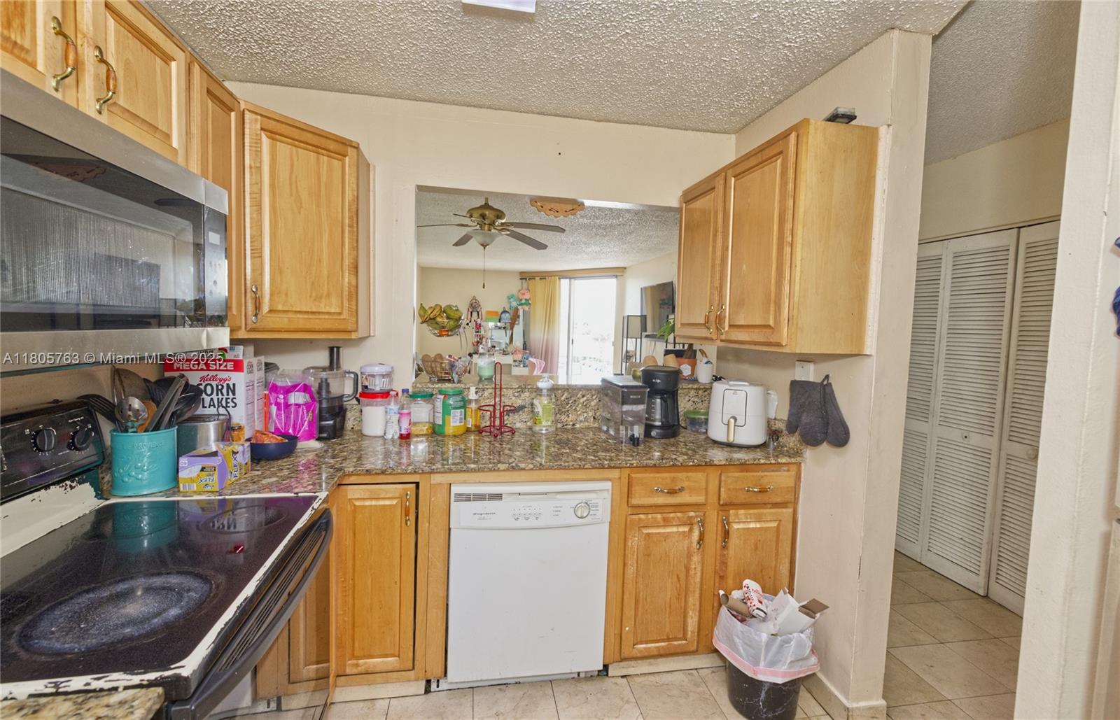 1750 West 46th Street, Unit 503 Hialeah, FL 33012 - Photo 9 of 24 a kitchen with stainless steel appliances granite countertop a sink stove and cabinets