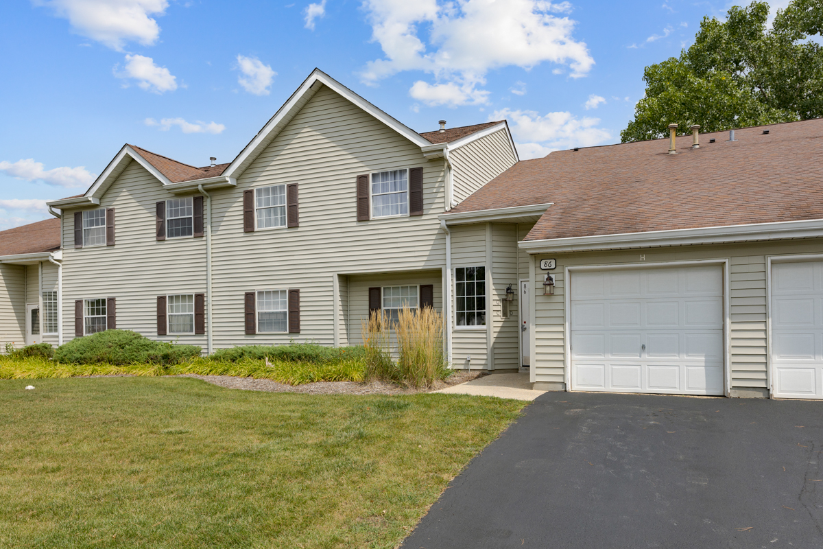 86 Gant Circle, Unit D Streamwood, IL 60107 - Photo 1 of 16 a front view of a house with garden