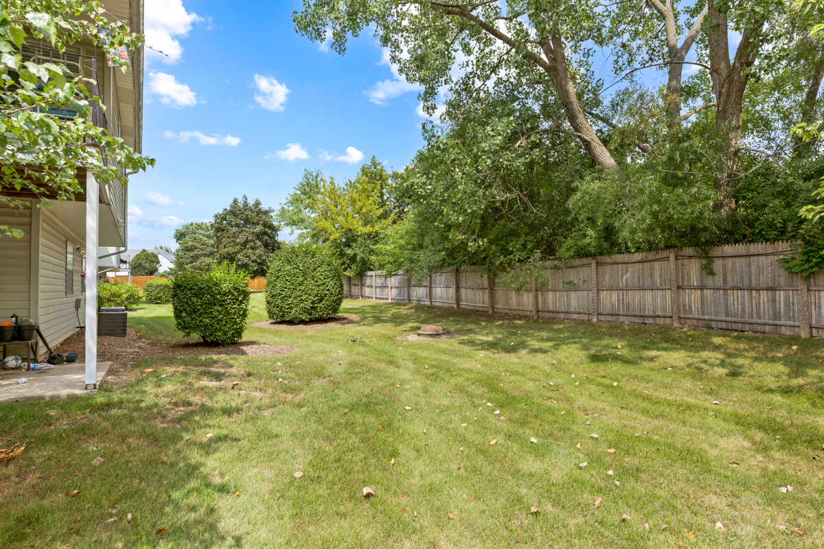 86 Gant Circle, Unit D Streamwood, IL 60107 - Photo 13 of 16 a view of a yard with a tree