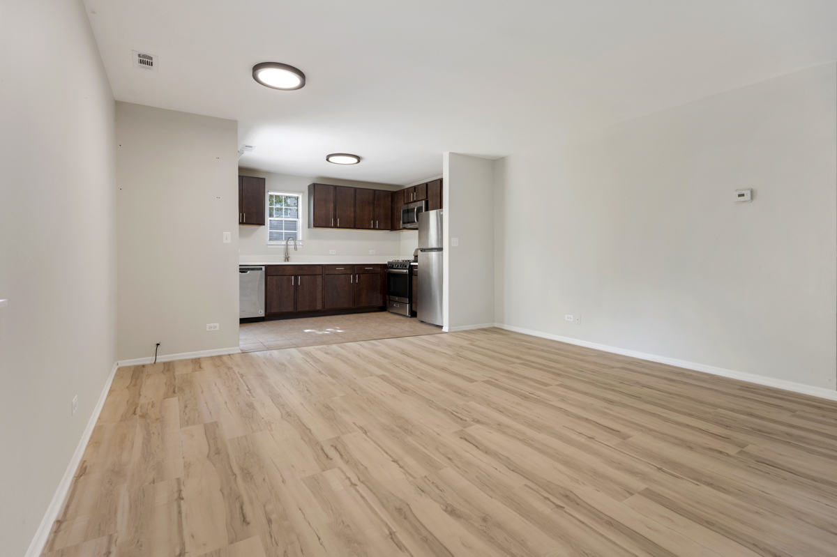 86 Gant Circle, Unit D Streamwood, IL 60107 - Photo 3 of 16 a view of a room with wooden floor and kitchen