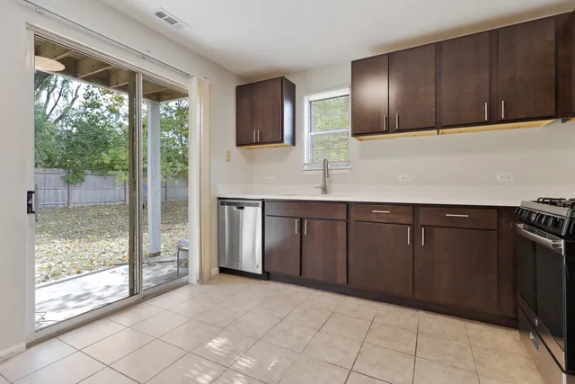 a kitchen with stainless steel appliances granite countertop a refrigerator and a sink